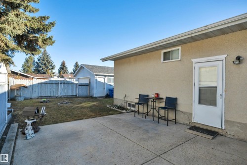 Fenced backyard featuring a patio and an outbuilding - 5312 36 Ave, Wetaskiwin, AB - Outdoor With Exterior