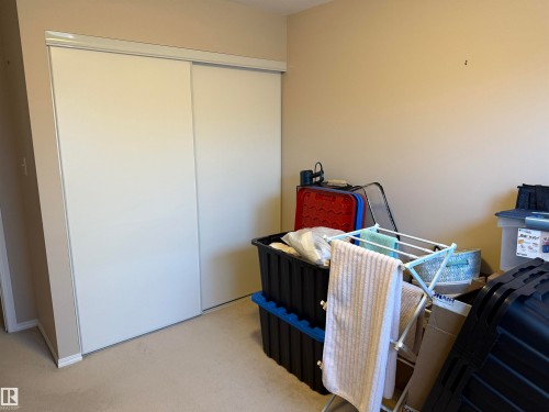 Bedroom featuring a closet and light carpet - 415 4700 43 Avenue, Stony Plain, AB - Indoor Photo Showing Bedroom
