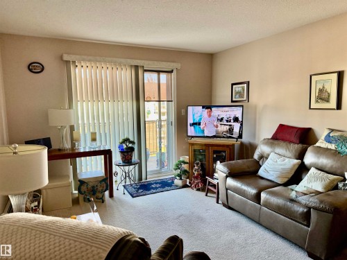 Living area featuring carpet and a textured ceiling - 415 4700 43 Avenue, Stony Plain, AB - Indoor Photo Showing Living Room