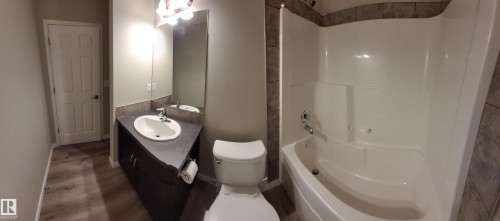 Full bath with vanity, shower / bathtub combination, and wood finished floors - 196, 142 Selkirk Place, Leduc, AB - Indoor Photo Showing Bathroom