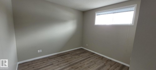 Spare room featuring wood finished floors and a textured ceiling - 196, 142 Selkirk Place, Leduc, AB - Indoor Photo Showing Other Room