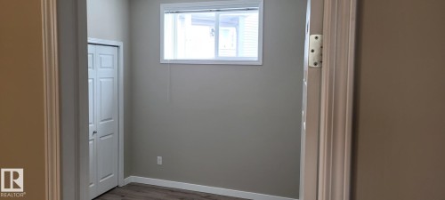 Bathroom with wood finished floors and baseboards - 196, 142 Selkirk Place, Leduc, AB - Indoor Photo Showing Other Room