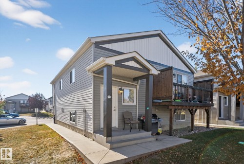 View of front of property featuring a front lawn and a wooden deck - 196, 142 Selkirk Place, Leduc, AB - Outdoor