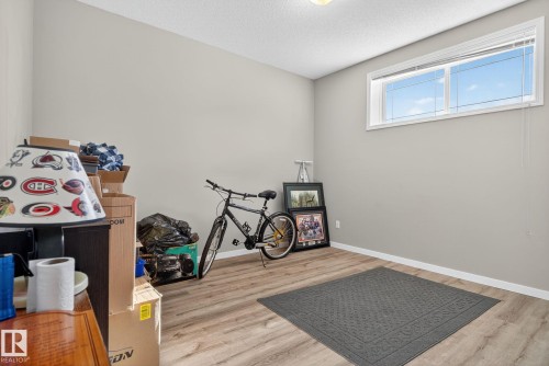 Miscellaneous room with light wood-style flooring and a textured ceiling - 196, 142 Selkirk Place, Leduc, AB - Indoor Photo Showing Other Room