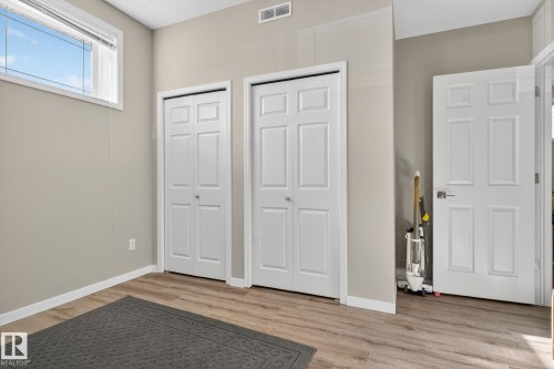 Unfurnished bedroom featuring multiple closets and light wood-type flooring - 196, 142 Selkirk Place, Leduc, AB - Indoor Photo Showing Other Room