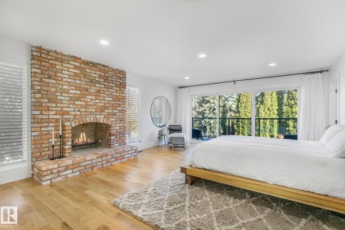 100 Wolf Willow Crescent, Edmonton, AB - Indoor Photo Showing Bedroom With Fireplace