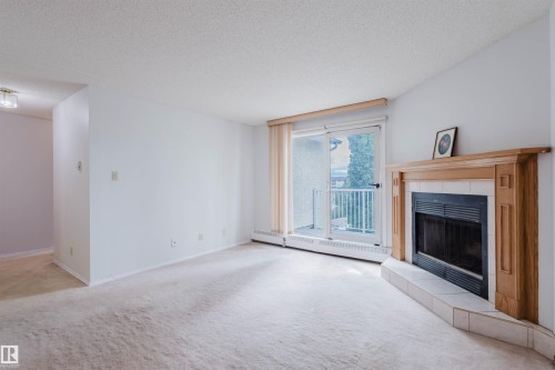 402 11020 19 Avenue, Edmonton, AB - Indoor Photo Showing Living Room With Fireplace