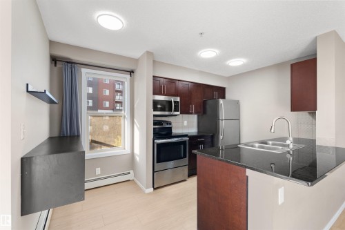 202 3315 James Mowatt Trail, Edmonton, AB - Indoor Photo Showing Kitchen With Double Sink