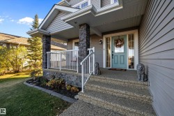 Doorway to property featuring covered porch and a lawn - 
