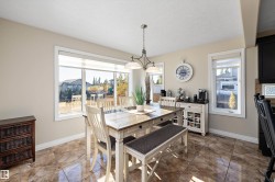 Dining area featuring a textured ceiling and dark tile patterned floors - 