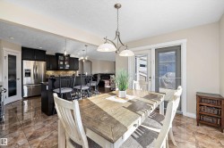 Dining room with a textured ceiling and baseboards - 