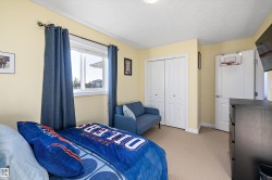 Bedroom with light carpet and a closet - 