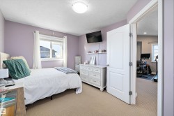 Bedroom with light colored carpet and a textured ceiling - 