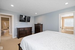 Bedroom featuring light carpet, recessed lighting, and a textured ceiling - 