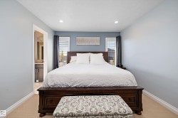 Bedroom featuring light colored carpet, connected bathroom, and recessed lighting - 
