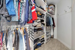Spacious closet with light tile patterned floors - 