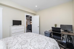 Bedroom featuring an office area, recessed lighting, and dark wood-style flooring - 