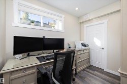Office with dark wood-type flooring and recessed lighting - 