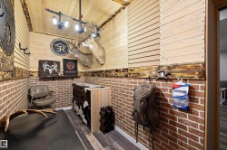 Bathroom featuring dark wood-style floors, wooden walls, and brick wall - 