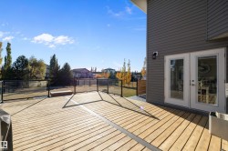Wooden deck featuring a residential view and french doors - 