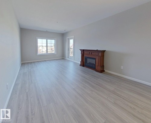 318 160 Magrath Road, Edmonton, AB - Indoor Photo Showing Living Room With Fireplace