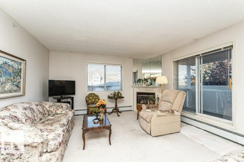 301 911 Rabbit Hill Road, Edmonton, AB - Indoor Photo Showing Living Room With Fireplace
