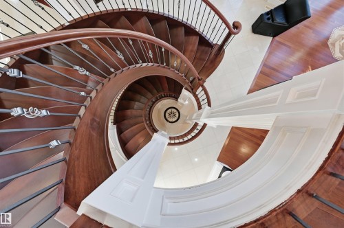 Custom floating spiral staircase with hardwood stringers and treads - 872 Hollands Landing, Edmonton, AB - Indoor Photo Showing Other Room