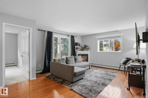 130 17447 98A Ave, Edmonton, AB - Indoor Photo Showing Living Room With Fireplace