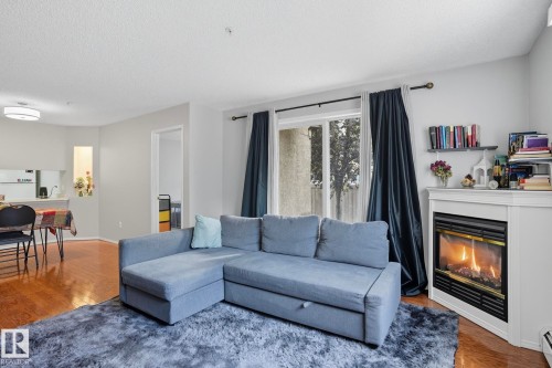 130 17447 98A Ave, Edmonton, AB - Indoor Photo Showing Living Room With Fireplace
