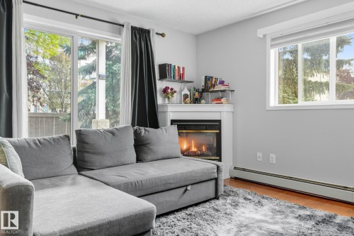 130 17447 98A Ave, Edmonton, AB - Indoor Photo Showing Living Room With Fireplace