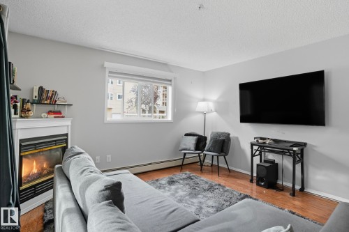 130 17447 98A Ave, Edmonton, AB - Indoor Photo Showing Living Room With Fireplace