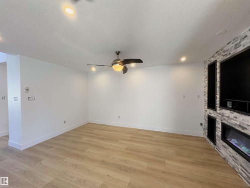 4337 21 Avenue, Edmonton, AB - Indoor Photo Showing Other Room With Fireplace