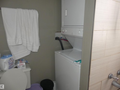 Washroom with stacked washing machine and dryer - 10618 96 Street Nw, Edmonton, AB - Indoor Photo Showing Laundry Room