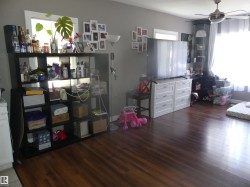 Bedroom featuring dark wood-type flooring and a ceiling fan - 