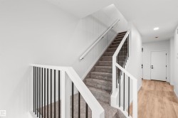 Stairway with wood finished floors and recessed lighting - 