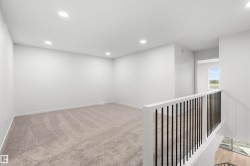 Unfurnished room featuring recessed lighting and light colored carpet - 