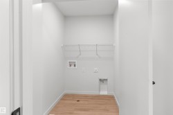 Laundry room with light wood-style flooring and washer hookup - 