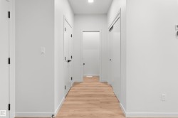 Hallway with light wood finished floors and recessed lighting - 