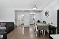 Dining room featuring dark wood-style floors, stairs, and a textured ceiling - 
