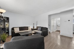 Living area with wood finished floors and stairway - 