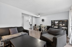 Living room with wood finished floors and a textured ceiling - 