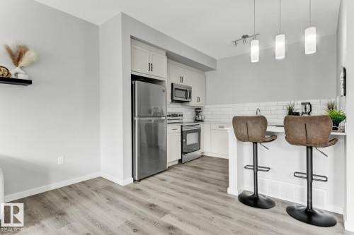 114 1304 Rutherford Rd, Edmonton, AB - Indoor Photo Showing Kitchen With Stainless Steel Kitchen