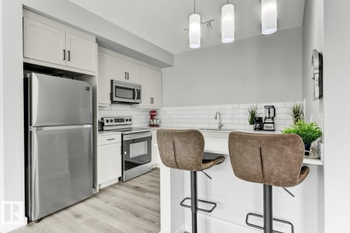 114 1304 Rutherford Rd, Edmonton, AB - Indoor Photo Showing Kitchen With Stainless Steel Kitchen