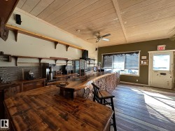 Kitchen featuring a wooden ceiling with exposed beams and ceiling fan - 