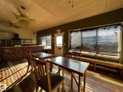 Dining space with wooden ceiling, a ceiling fan, and wood-type flooring - 