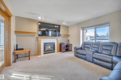113 Pipestone Drive, Millet, AB - Indoor Photo Showing Living Room With Fireplace
