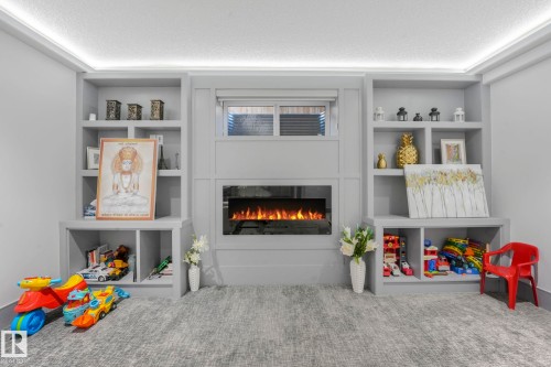 3510 Watson Point(E), Edmonton, AB - Indoor Photo Showing Other Room With Fireplace