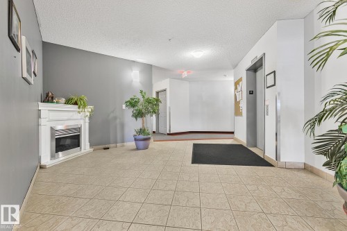 308 9120 156 Street, Edmonton, AB - Indoor Photo Showing Other Room With Fireplace