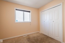 Unfurnished bedroom with carpet flooring and a closet - 