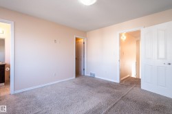 Unfurnished bedroom with carpet flooring and connected bathroom - 